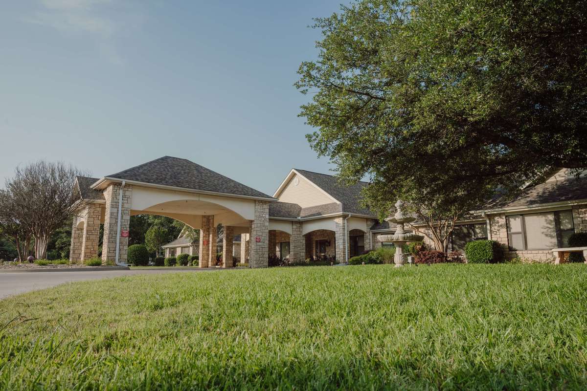 Warm home exterior with mature trees